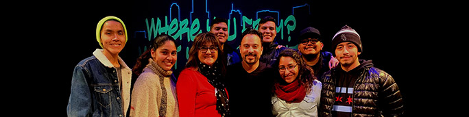 Group of Latino/a students posing on a stage.